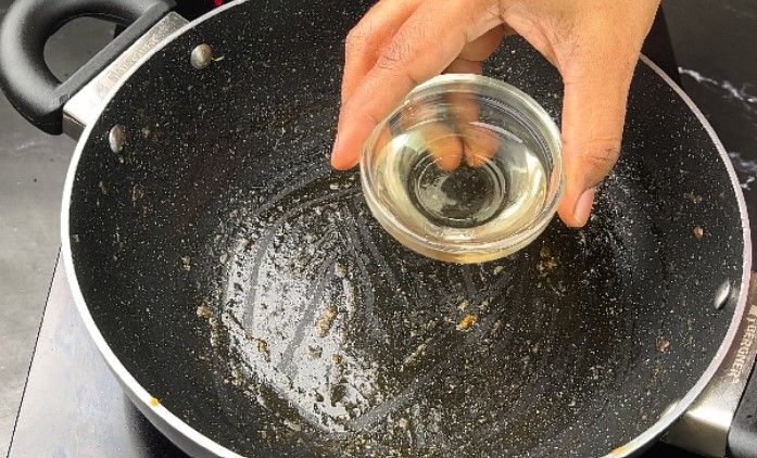 Step 2.1: In a large kadai, heat oil and sauté cumin, cinnamon, cardamom pods, and bay leaf