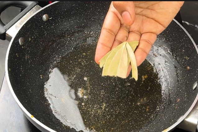 Step 2.2: In a large kadai, heat oil and sauté cumin, cinnamon, cardamom pods, and bay leaf