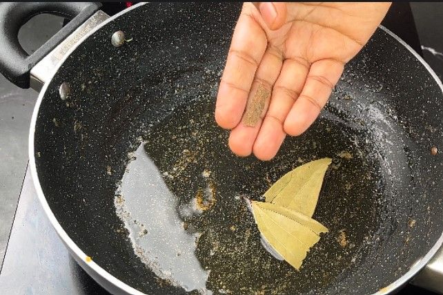 Step 2.3: In a large kadai, heat oil and sauté cumin, cinnamon, cardamom pods, and bay leaf