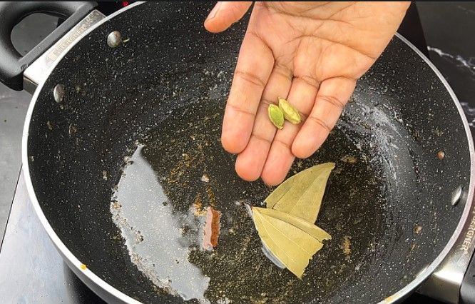 Step 2.4: In a large kadai, heat oil and sauté cumin, cinnamon, cardamom pods, and bay leaf