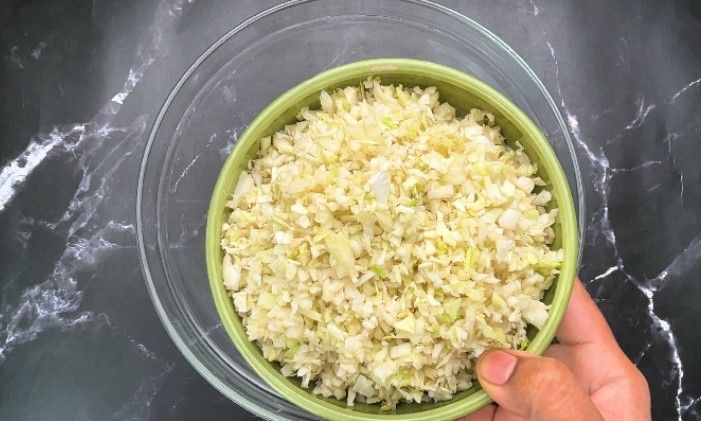 Step 1.1: In a large bowl, combine finely chopped cabbage, grated carrot, chili powder, pepper powder, salt, and ginger garlic paste