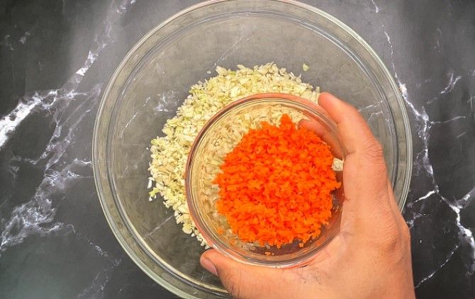 Step 1.2: In a large bowl, combine finely chopped cabbage, grated carrot, chili powder, pepper powder, salt, and ginger garlic paste