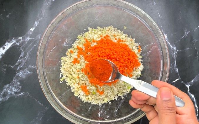 Step 1.3: In a large bowl, combine finely chopped cabbage, grated carrot, chili powder, pepper powder, salt, and ginger garlic paste