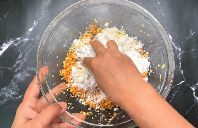 Step 1.4: Add maida (all-purpose flour) and corn flour to the mixture