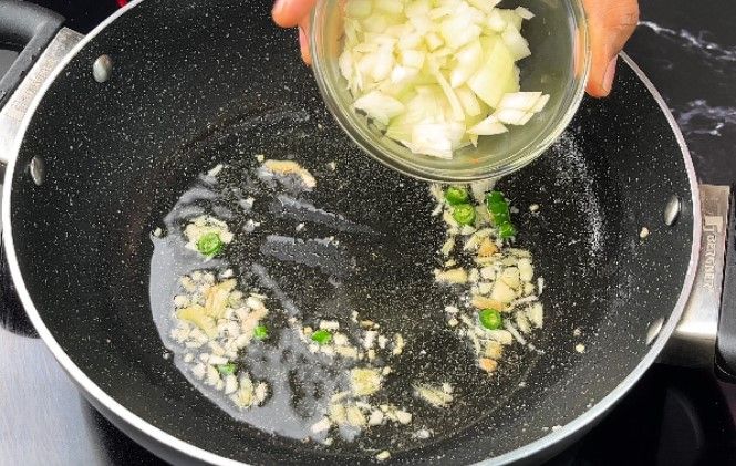 Step 2.1: Add finely chopped onion and capsicum
