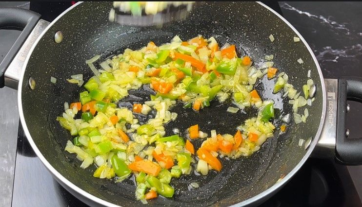 Step 2.6: Add finely chopped onion and capsicum