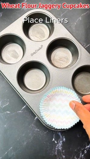 Step 1.2: Take a muffin tray, grease it with butter, and place liners inside