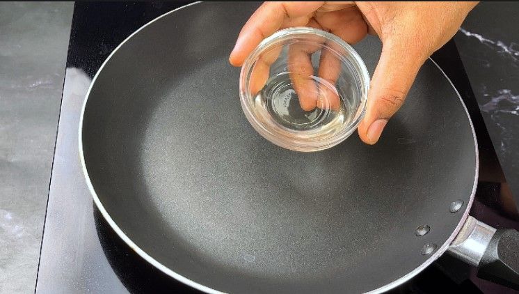 Step 2.2: In a pan, heat oil over low to medium flame