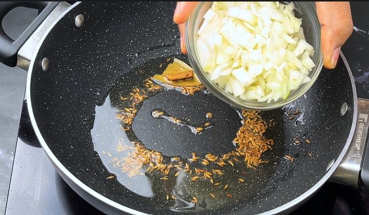 Step 4.1: Add finely chopped onions to the pan