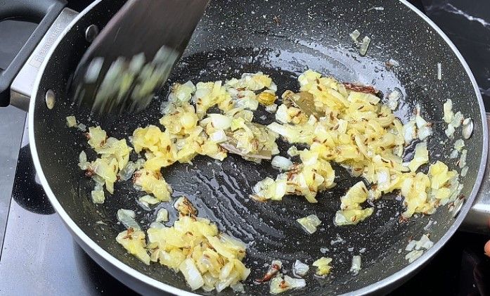 Step 5.2: Stir in ginger-garlic paste and sauté until the raw smell disappears