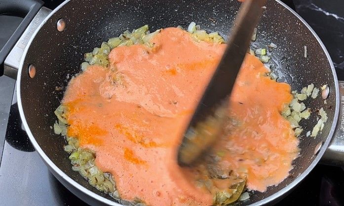Step 6.2: Add this mixture to the pan and sauté until the oil starts to separate from the curry