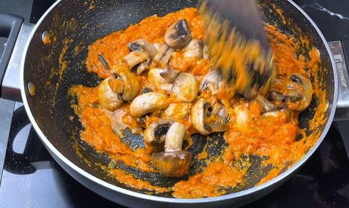 Step 8.2: Add the sautéed mushrooms to the pan and mix well