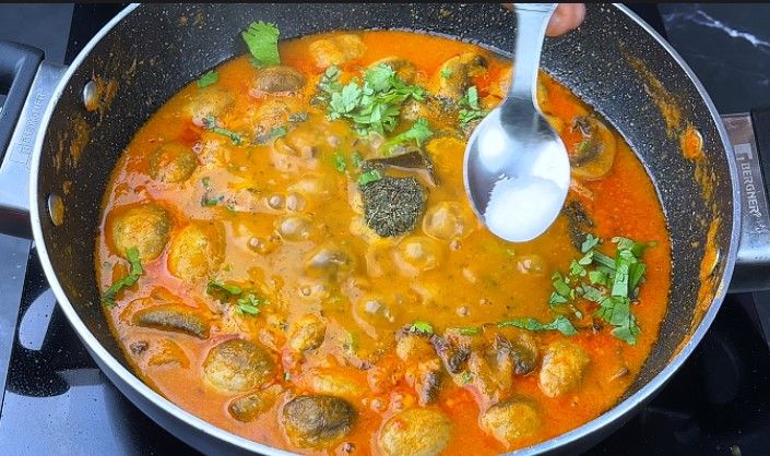 Step 9.4: After 10 minutes, open the lid and add garam masala, kasuri methi, and chopped coriander leaves