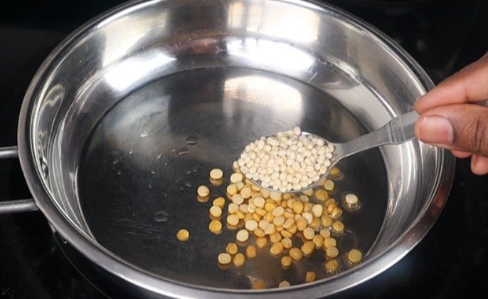 Step 1.2: Add chana dal, urad dal, coriander seeds, cumin seeds, methi, black pepper, and dried red chilies