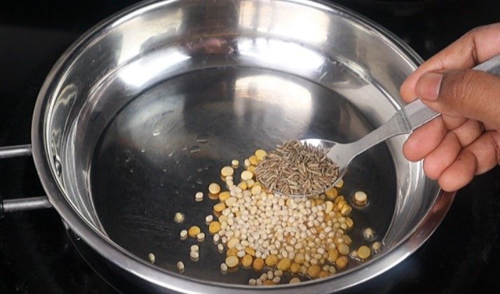 Step 1.3: Add chana dal, urad dal, coriander seeds, cumin seeds, methi, black pepper, and dried red chilies