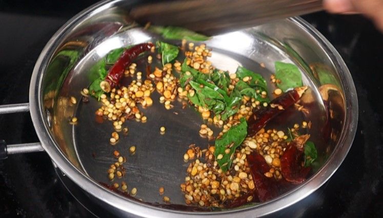 Step 1.2: Add curry leaves and grated coconut