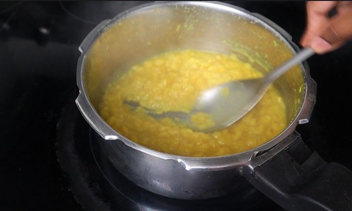 Step 2.2: Once the pressure releases naturally, open the cooker and mix the cooked dal to a smooth consistency
