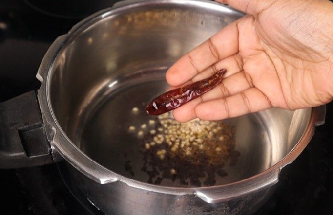 Step 3.4: Add mustard seeds and cumin seeds, urad dal, dried red chili, and curry leaves