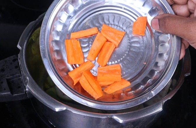 Step 3.3: Add the chopped brinjal, potato, bottle gourd, carrot, tomato slices, and salt Stir fry for a few minutes