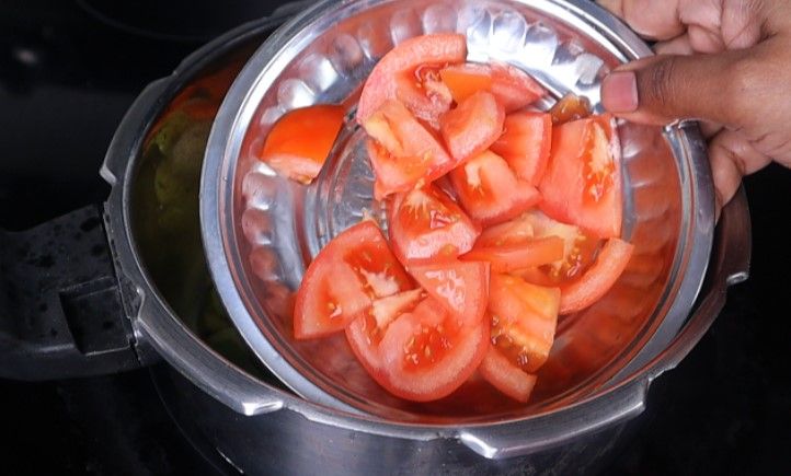 Step 3.4: Add the chopped brinjal, potato, bottle gourd, carrot, tomato slices, and salt Stir fry for a few minutes