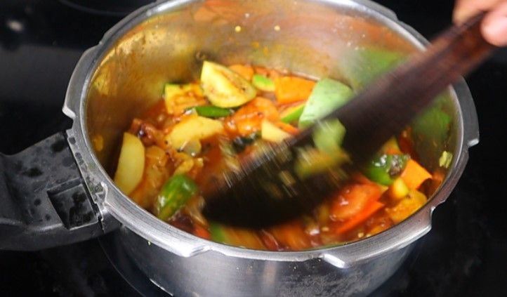 Step 3.2: Pour in the tamarind extract, cover with a lid, and cook for 2 minutes on low flame