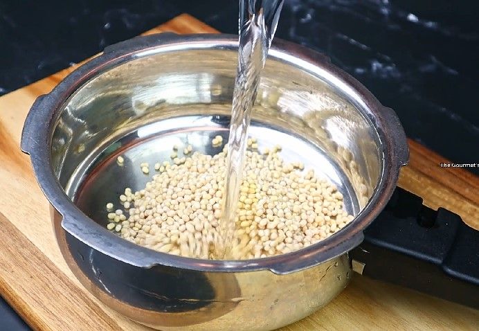 Step 1.2: Take 1/2 cup of urad dal, rinse well, and pressure cook it with sufficient water for 3-4 whistles or until soft and mushy