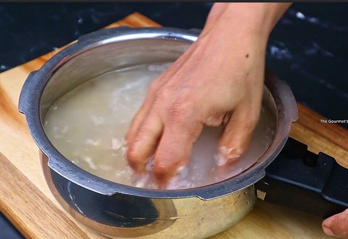 Step 1.3: Take 1/2 cup of urad dal, rinse well, and pressure cook it with sufficient water for 3-4 whistles or until soft and mushy