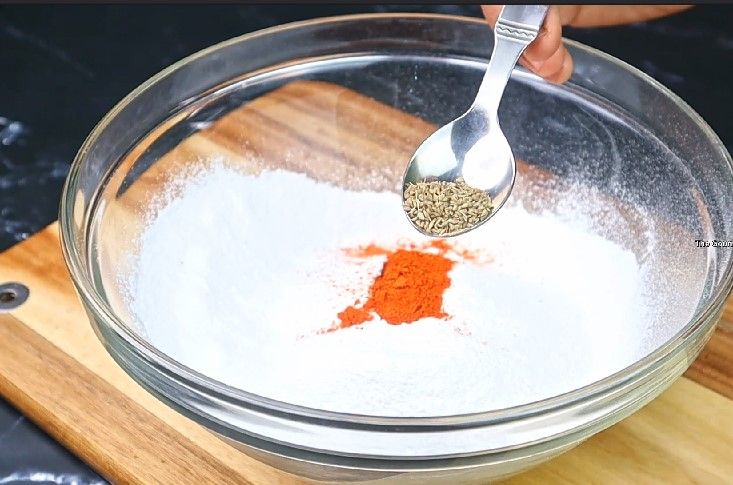Step 2.4: In a mixing bowl, combine rice flour, mashed urad dal, butter or hot oil, carrom seeds, asafoetida, chili powder, and salt