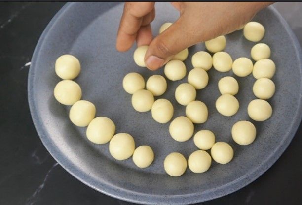 Step 2.5: Apply ghee to your hands and gently take a small amount of dough