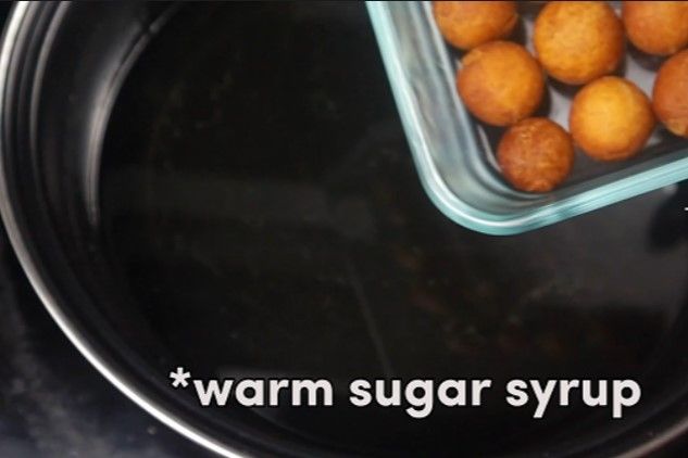Step 2.1: Transfer the fried jamuns into the warm sugar syrup