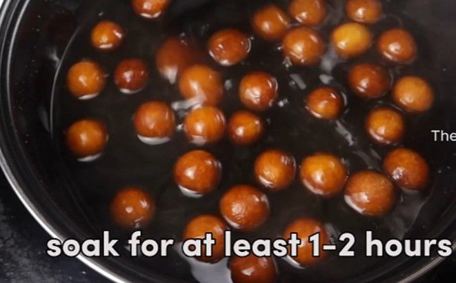 Step 2.2: Transfer the fried jamuns into the warm sugar syrup