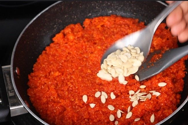 Step 4.4: Add cardamom powder, ghee, and Watermelon seeds and mix well