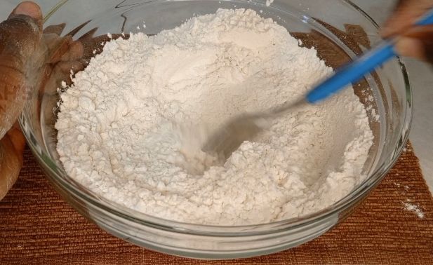 Step 1.4: In a large bowl mix flour ,salt by adding cold water gradually to form a nice rough dough