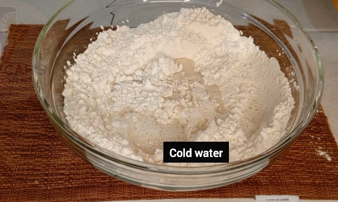 Step 1.3: In a large bowl mix flour ,salt by adding cold water gradually to form a nice rough dough