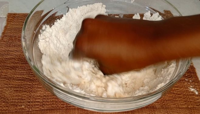Step 1.2: In a large bowl mix flour ,salt by adding cold water gradually to form a nice rough dough
