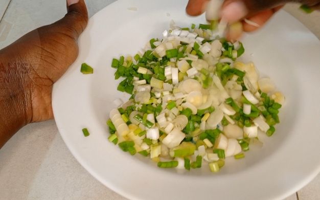 Step 1.2: Cut them into quarters,and later prepare the sauce that'll be use to stick together the parts , prepare the green grams altogether with the sliced spring onions, don't forget to add salt to taste
