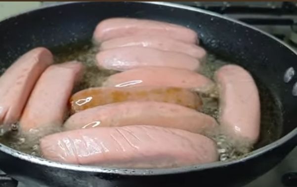 Step 1.1: Heat the Oil: Pour enough vegetable oil into a deep frying pan or wok to submerge the sausages about halfway