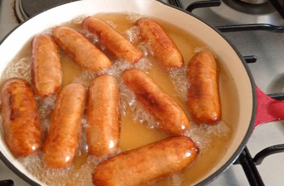 Step 1.3: Heat the Oil: Pour enough vegetable oil into a deep frying pan or wok to submerge the sausages about halfway