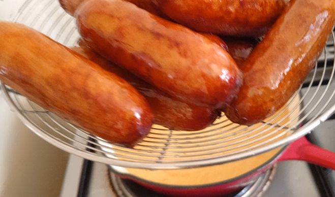Step 1.2: Use tongs to remove the sausages from the oil and place them on a paper towel-lined plate to drain excess oil