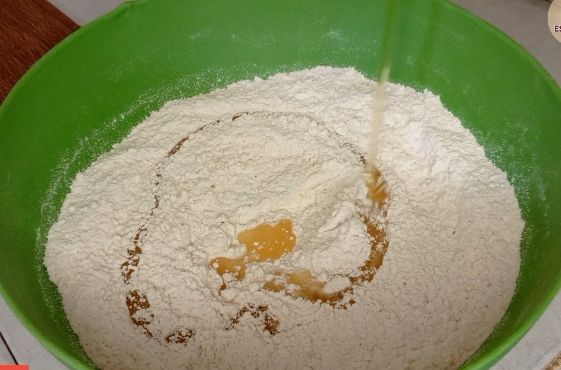 Step 1.3: Gradually add milk to the dry ingredients and knead until a soft dough forms