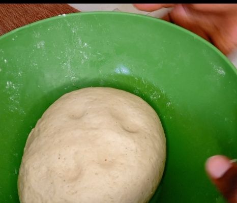 Step 1.1: Gradually add milk to the dry ingredients and knead until a soft dough forms