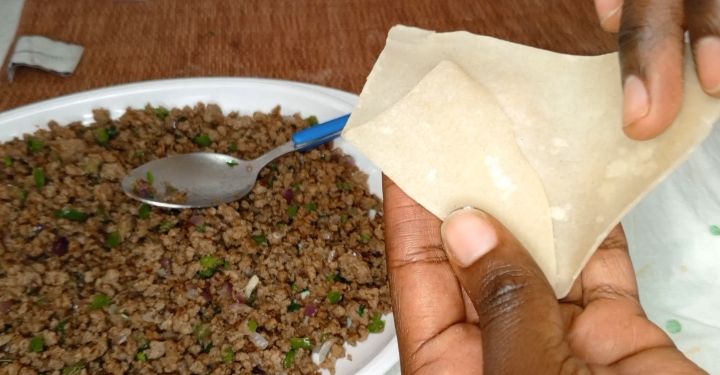 Step 2.2: Take a samosa wrap and place a spoonful of the filling in the center
