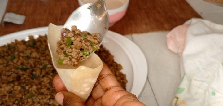 Step 2.1: Take a samosa wrap and place a spoonful of the filling in the center