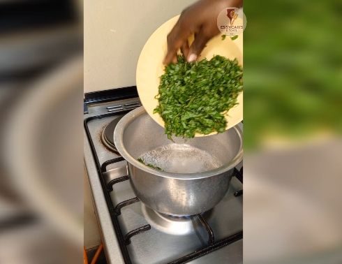 Step 2.4: In a large pot over medium heat, bring water to boil and add in soda ash, jute mallow and later in add spinach leaves cook until they begin to wilt