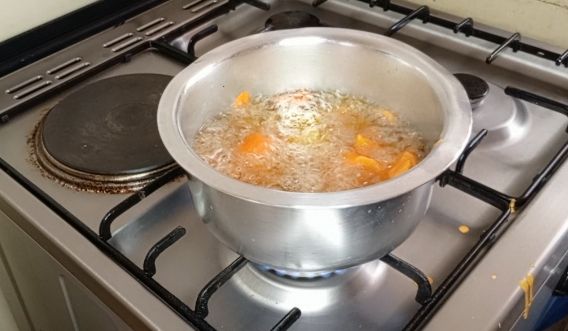 Step 1.2: From the boiled potatoes, cut them into small pieces and deep them inside the prepared batter and toss them gently to coat evenly