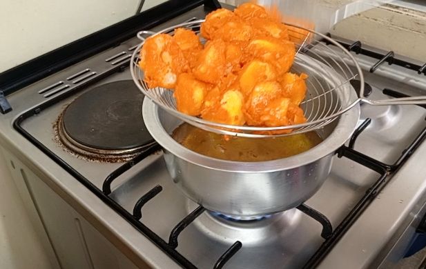 Step 1.1: From the boiled potatoes, cut them into small pieces and deep them inside the prepared batter and toss them gently to coat evenly