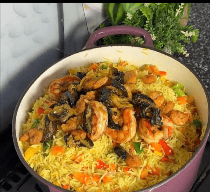Step 2.1: Once the rice is cooked, add the mixed vegetables and stir well to combine