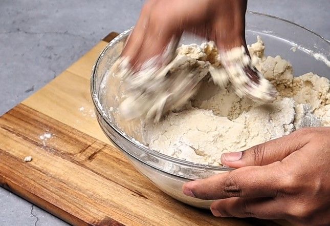 Step 1.3: Pour the hot water mixture into the dry ingredients, stirring continuously with a spatula