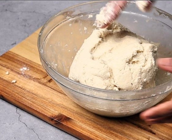 Step 1.4: Pour the hot water mixture into the dry ingredients, stirring continuously with a spatula
