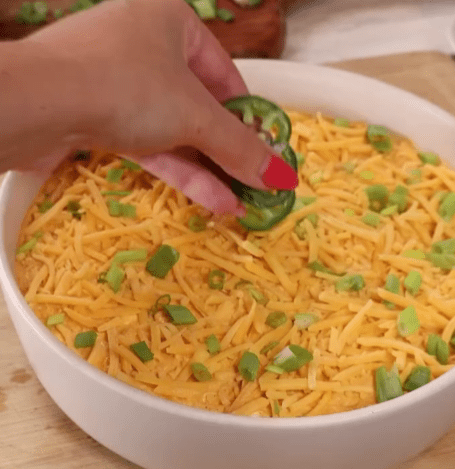 Step 1.1: Transfer the mixture to an oven-safe dish, top with extra cheddar cheese, and bake at 350°F for 20-25 minutes until bubbly and golden brown on top